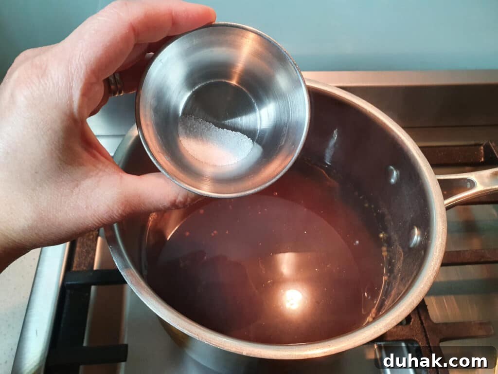 How to Make Homemade Cola Soda from Scratch 13 adding citric acid to pot.