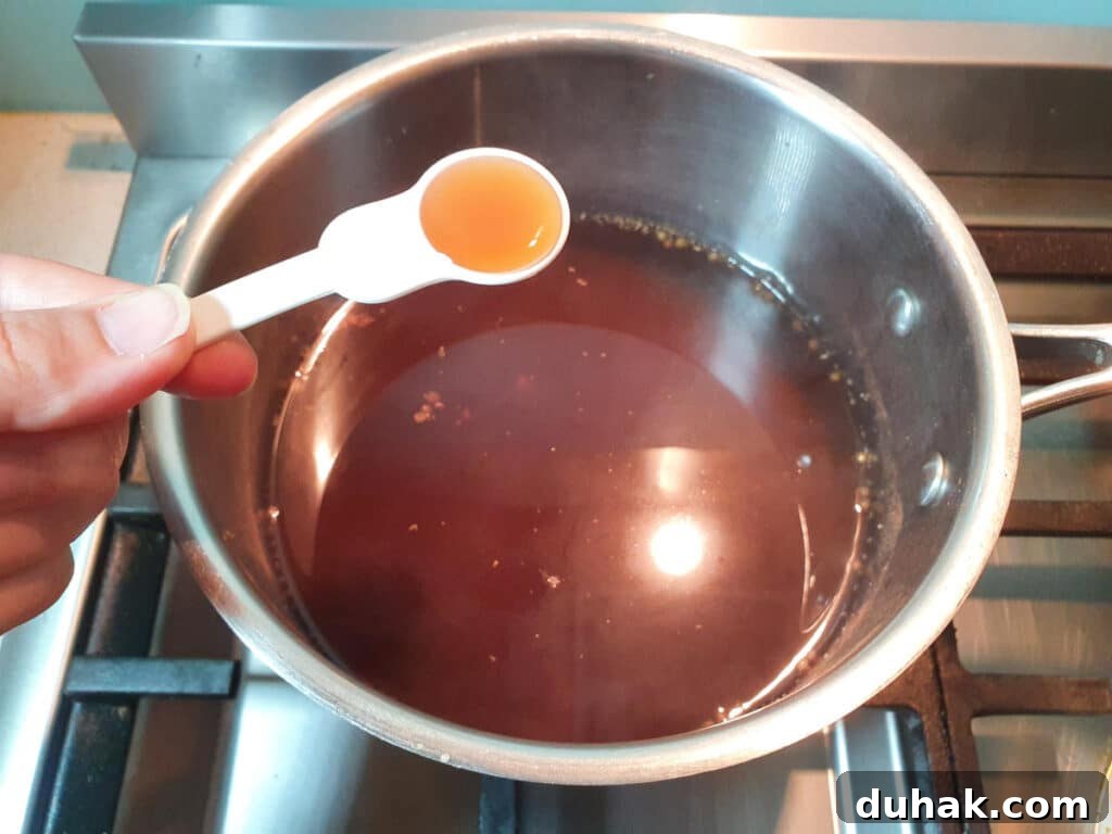 How to Make Homemade Cola Soda from Scratch 14 adding vanilla to saucepan.