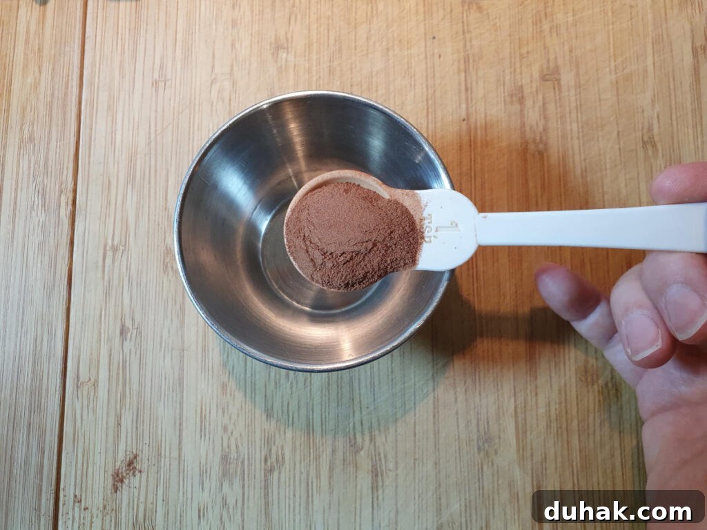How to Make Homemade Cola Soda from Scratch 7 measuring cinnamon into a small bowl.