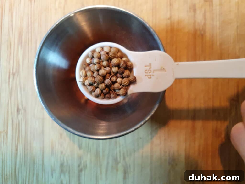 How to Make Homemade Cola Soda from Scratch 9 measuring corriander seeds into a small bowl.