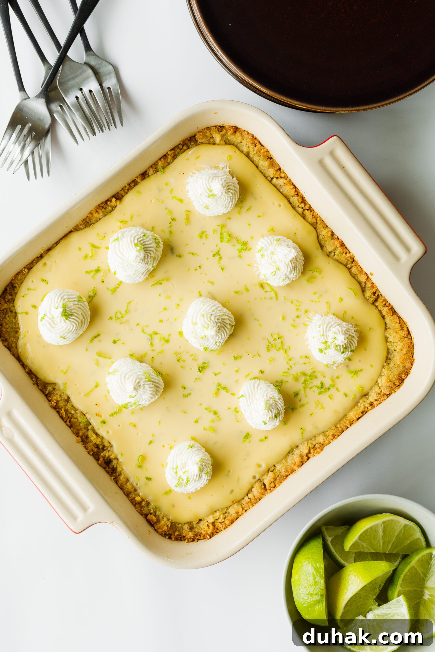 Start or Join a Book Club: Friends, Food, and Fellowship 2 The Key Lime Pie Bars, surrounded by forks, slices limes, and serving plates
