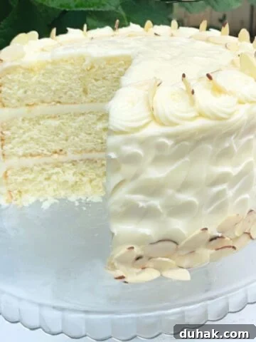 Almond Cake, sliced on a glass pedestal.