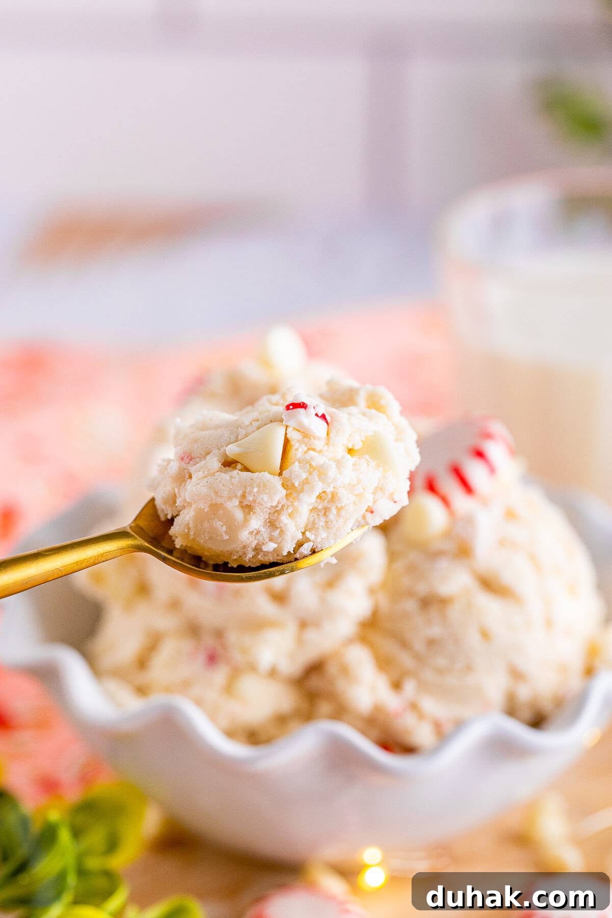 a spoon holding up a bite of easy edible cookie dough recipe in air