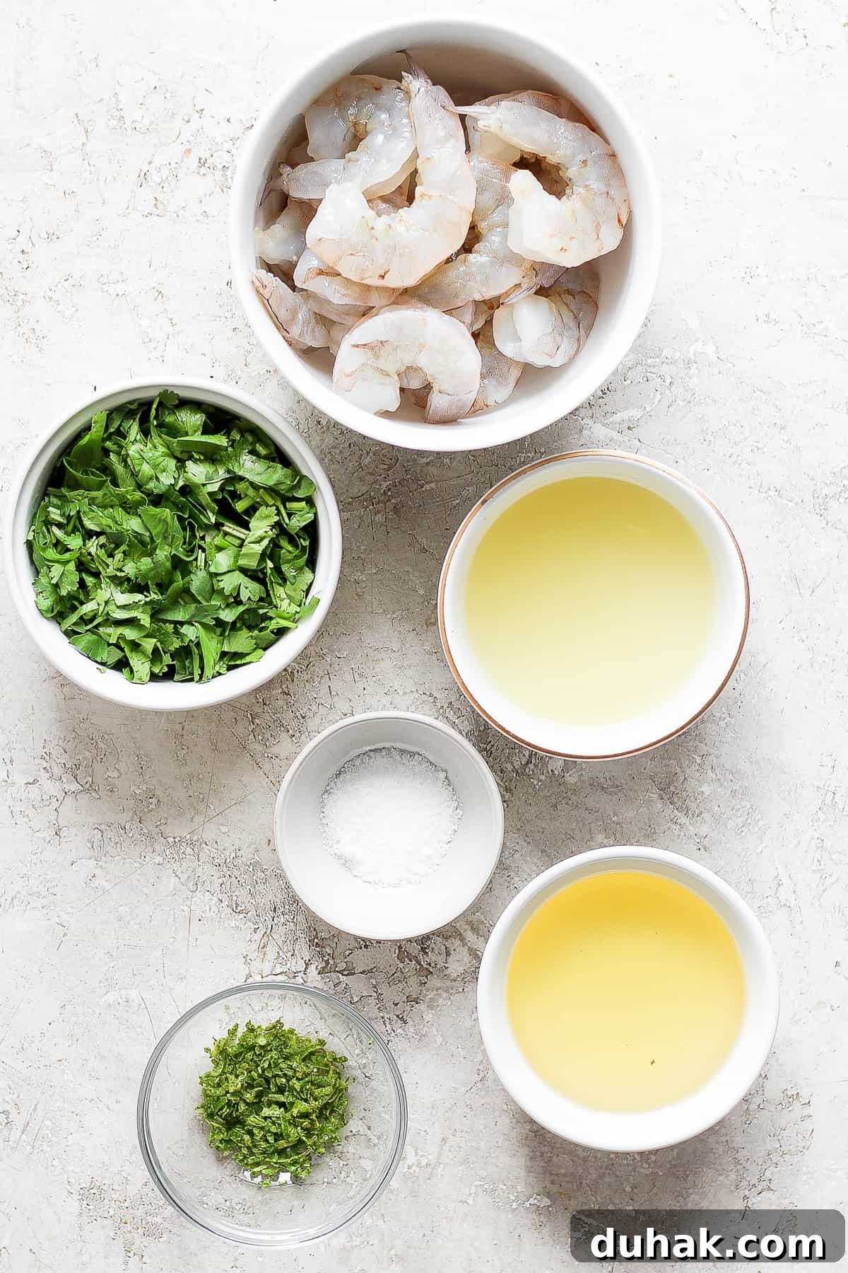Cilantro-Lime Shrimp Bowl with Creamy Cilantro-Lime Sauce 3 Raw shrimp and marinade ingredients in separate bowls.