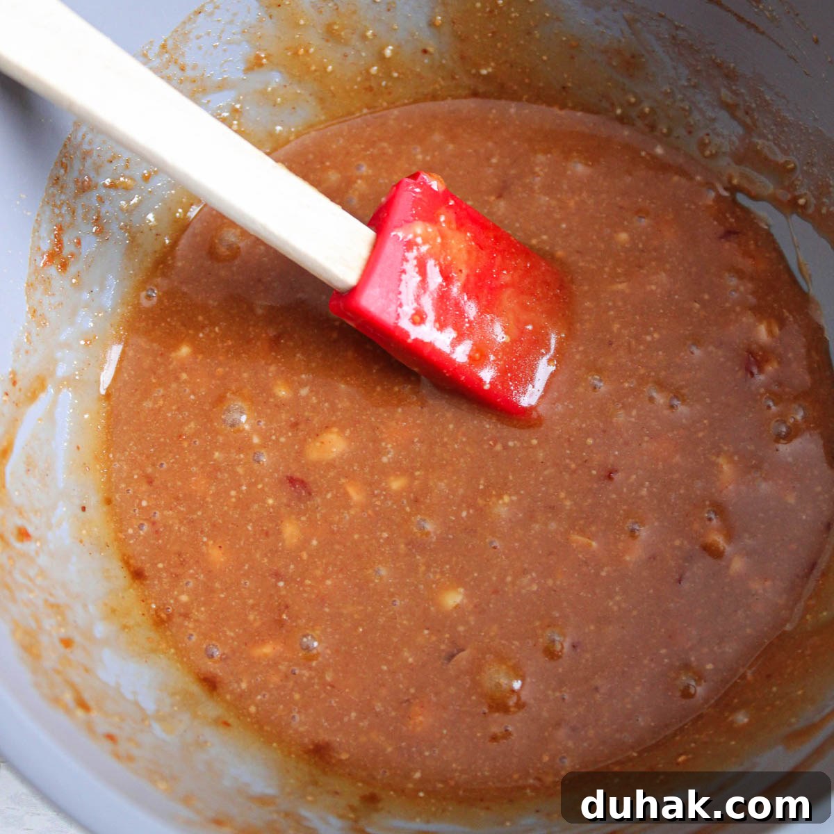 Mixed Thai peanut butter sauce  mixed together in a mixing bowl. 
