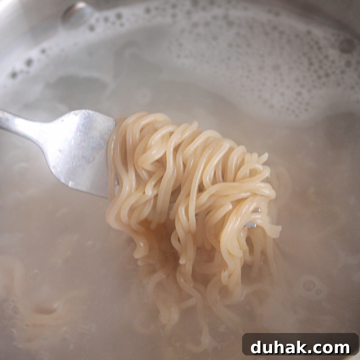 Boiled ramen noodles in water.
