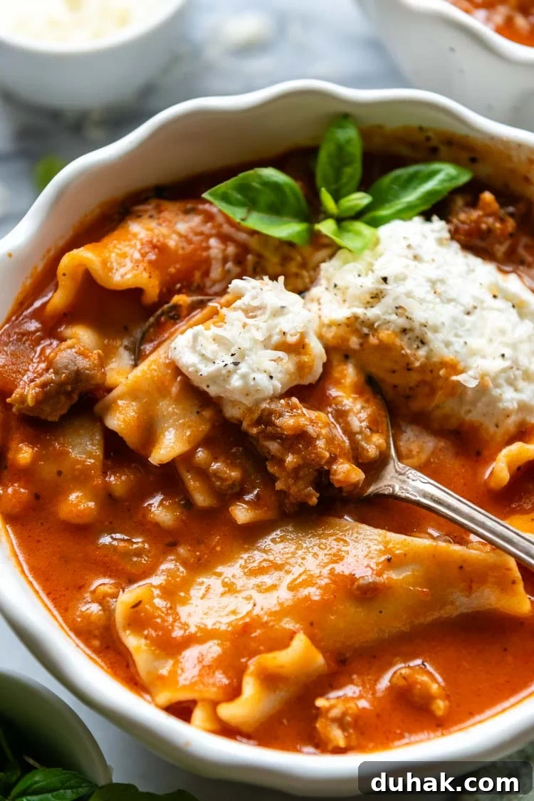 30-Minute Gluten-Free Lasagna Soup Recipe — Hearty & Homemade 2 Gluten-Free Lasagna Soup displayed in a white bowl with a garnish of greenery and a spoon.