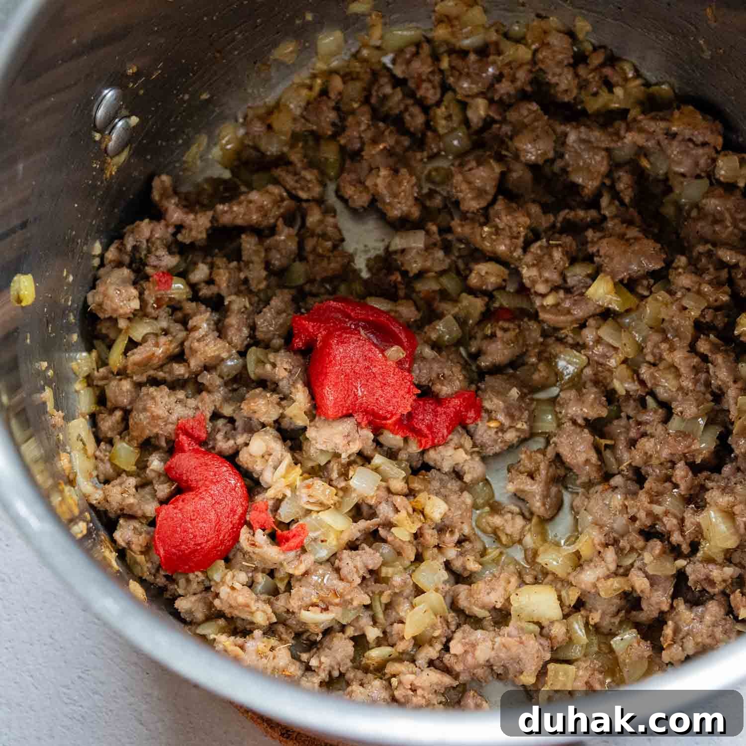 30-Minute Gluten-Free Lasagna Soup Recipe — Hearty & Homemade 3 Pot of cooked sausage and a dollop of tomato paste.