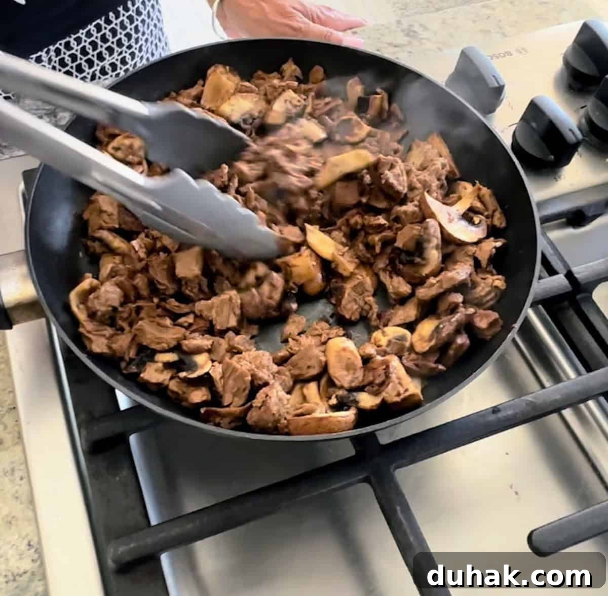 Beyond Steak Tips: Flavorful Marinated Beef Skewers Recipe 6 Mushrooms and steak tips cooking in a pan.