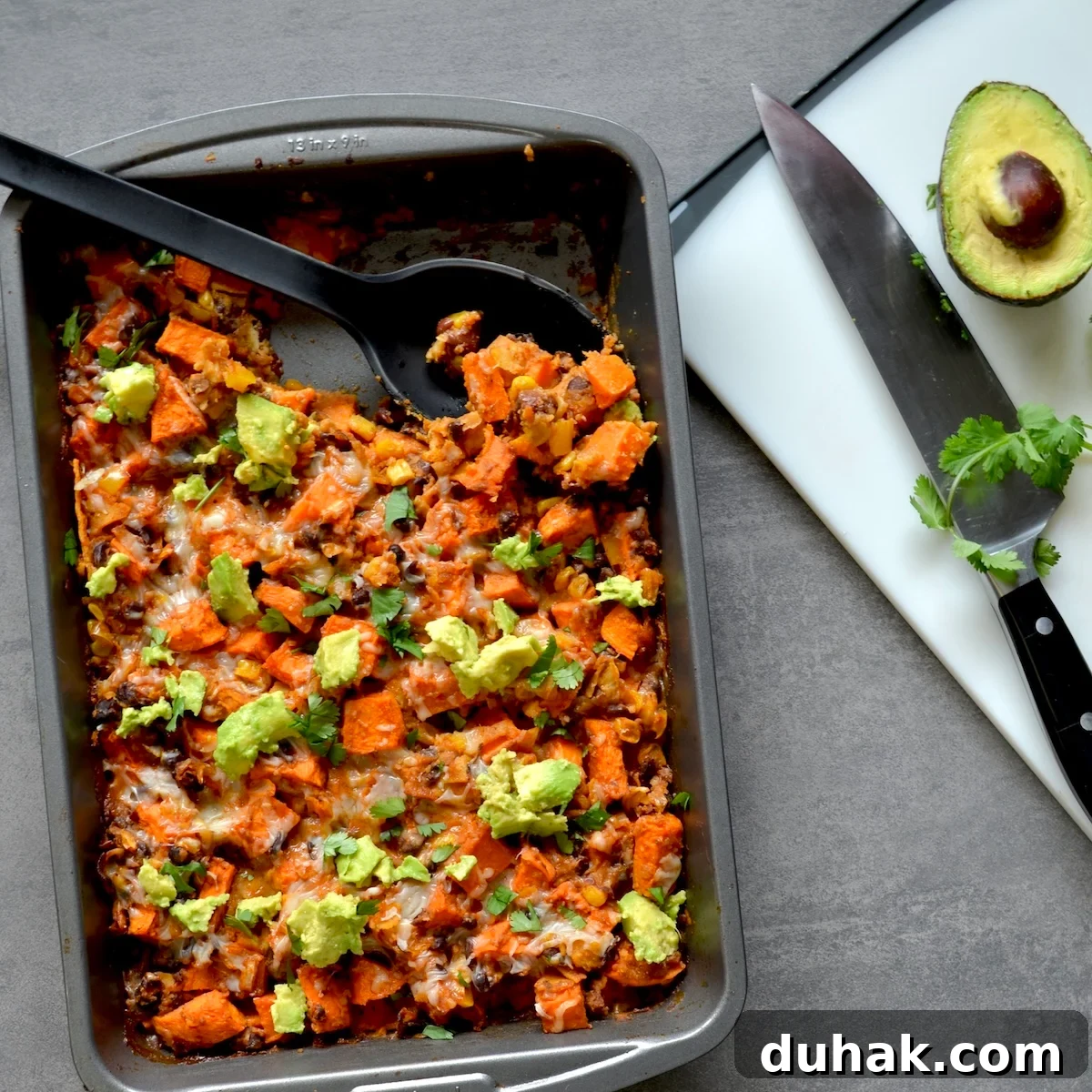 Enchilada casserole with  avocado pieces