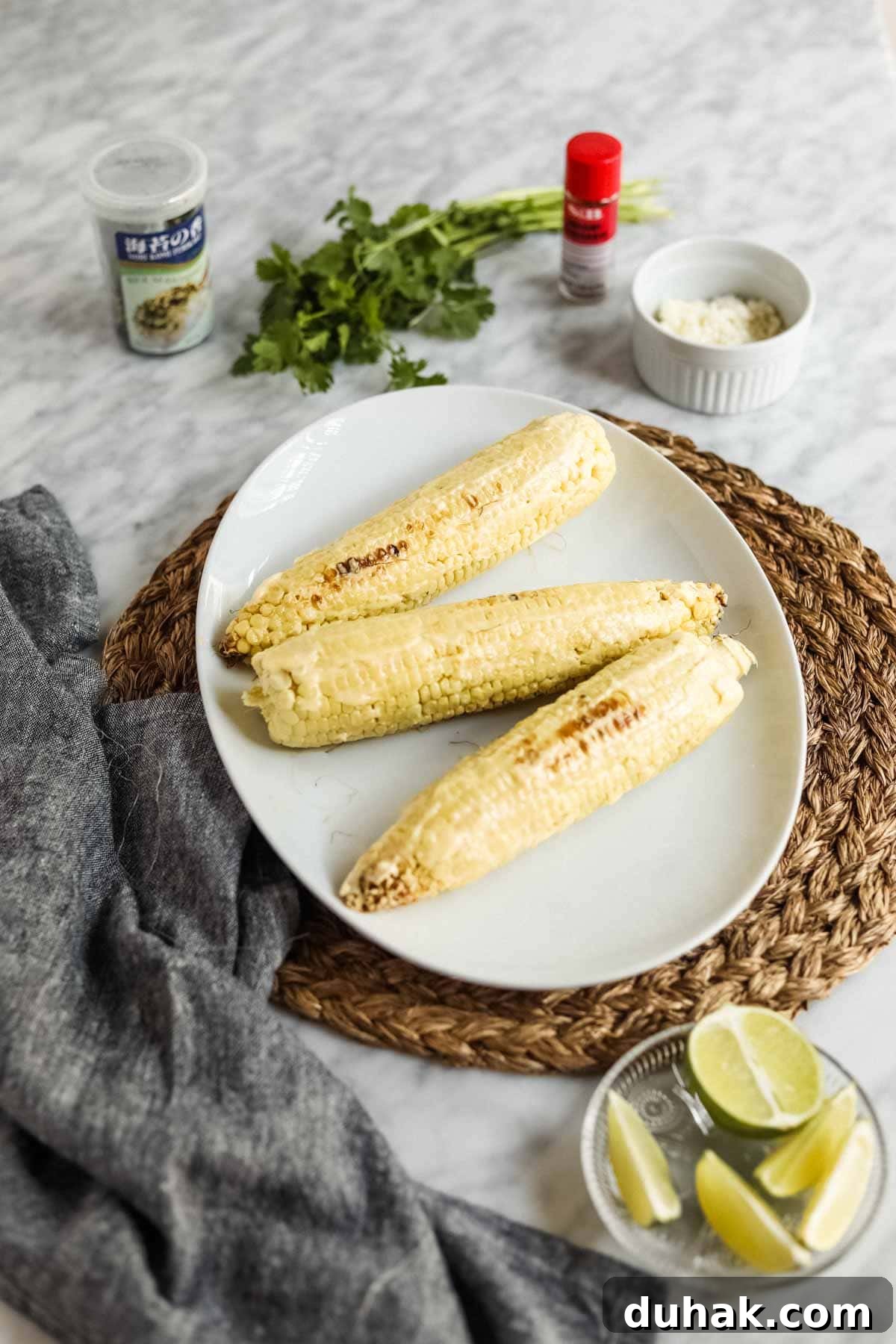 Elote-style corn with kewpie mayo and limes.