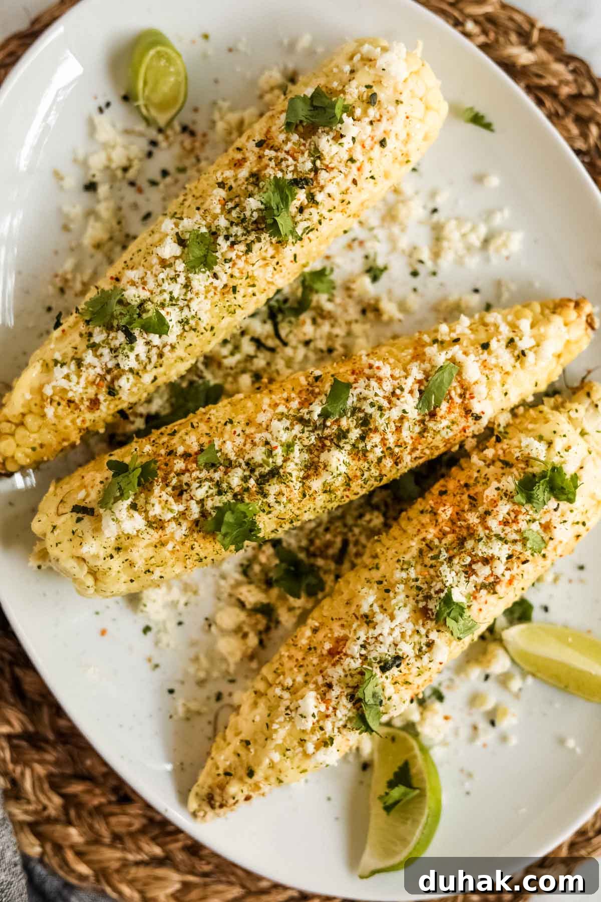 Elote-style corn with furikake and kewpie mayo on a plate flatlay.