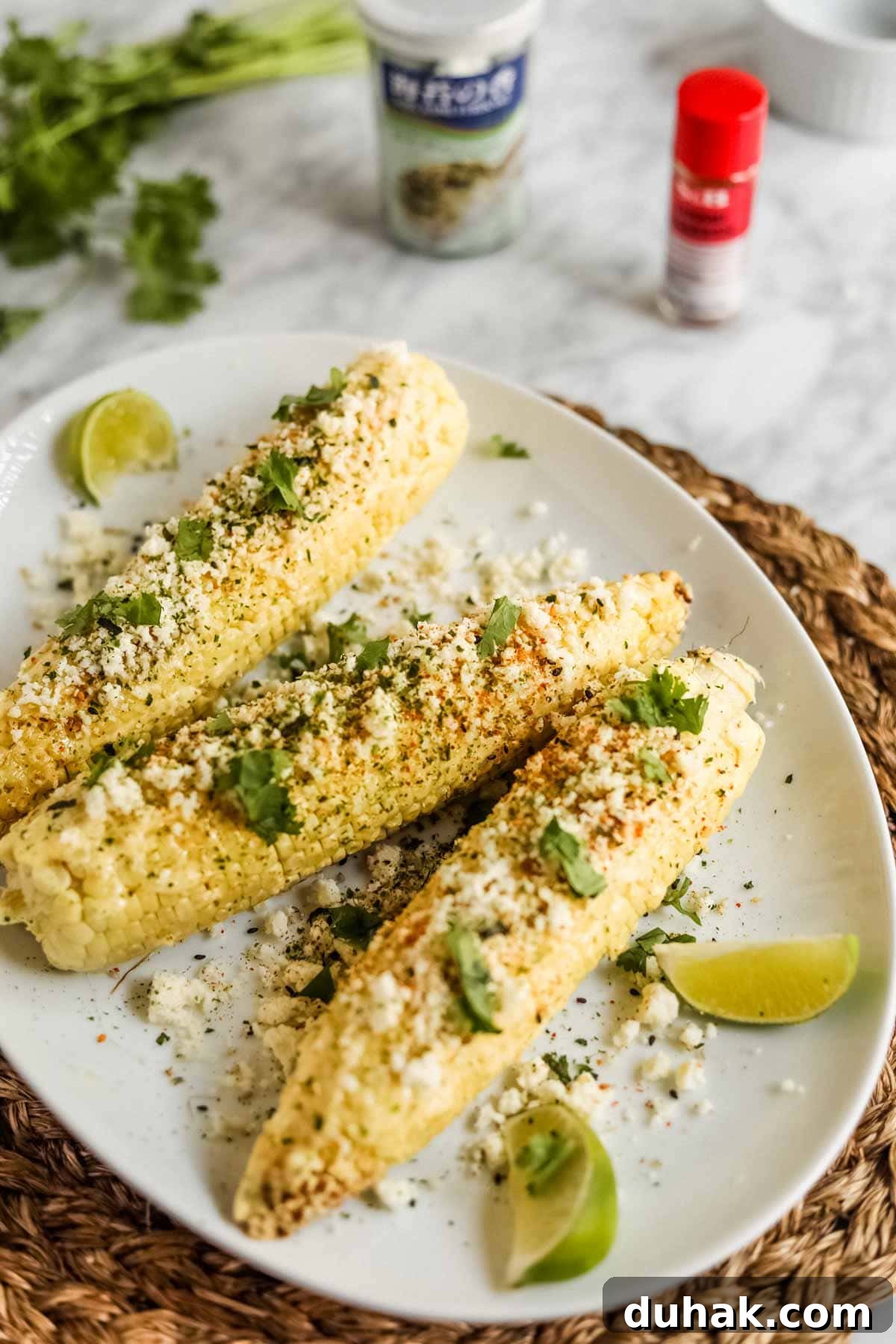 Elote-style corn with furikake, kewpie mayo, and limes..
