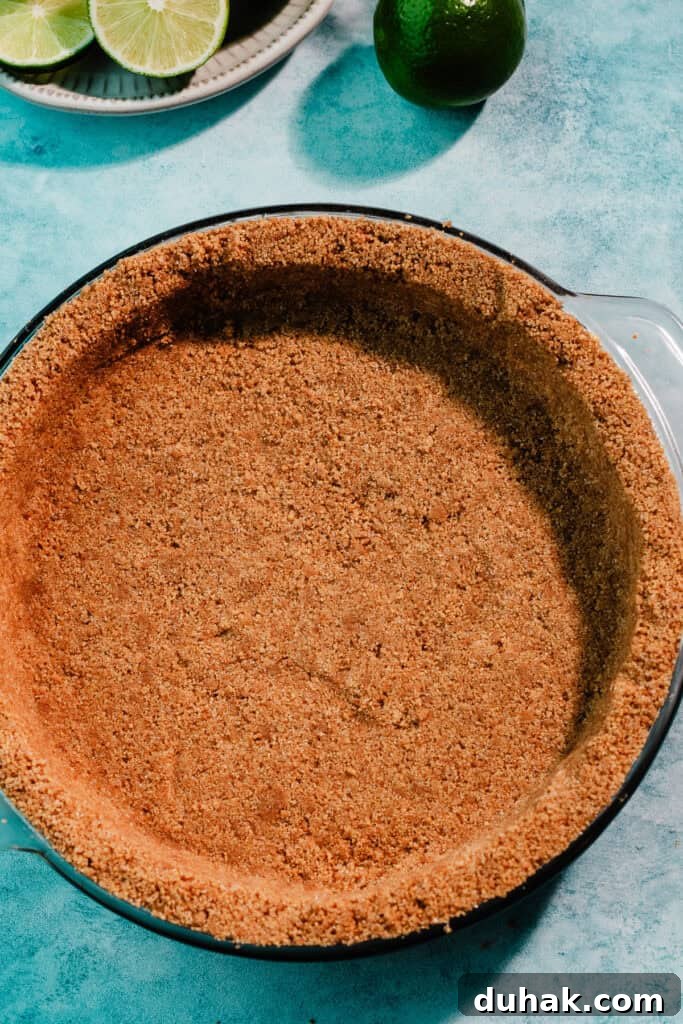 The crust pressed into a 9-inch pie dish, before being baked.