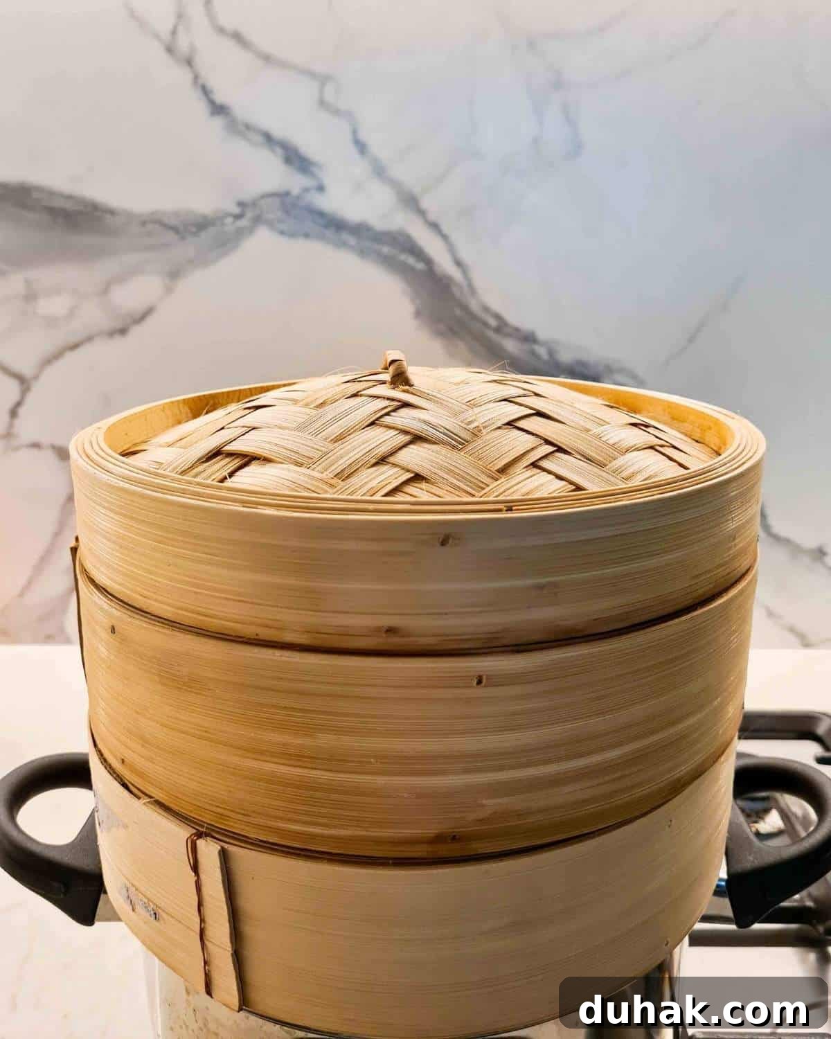 Dumplings being steamed inside bamboo steamer baskets