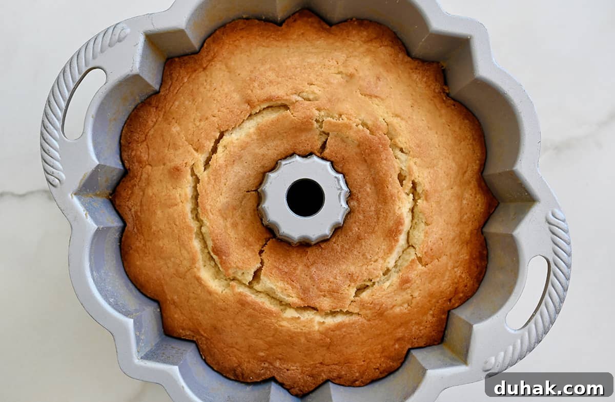 Glazed Lemon Pound Cake Recipe with Zesty Drizzle 5 A golden brown cake in a bundt pan.
