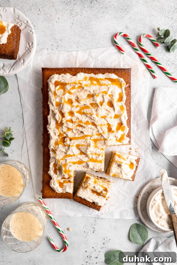 Bourbon Eggnog Sheet Cake with fluffy eggnog frosting, drizzled with caramel sauce