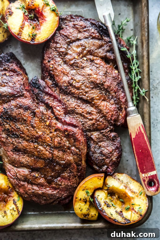 Grilled Ribeye with Caramelized Peaches and Herb Butter 3 grilled ribeye steaks with peaches www.thecuriousplate.com
