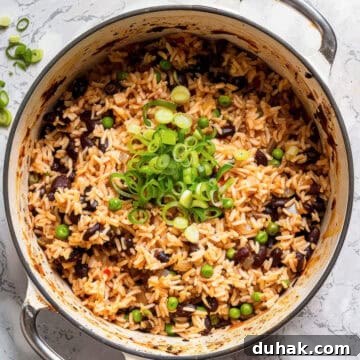 7-Day Aldi Budget Meal Plan: Dec 21–27 Weekly Menu 3 Easy rice and peas in a pot with green onions.