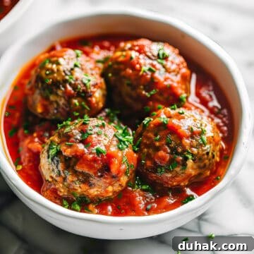 7-Day Aldi Budget Meal Plan: Dec 21–27 Weekly Menu 4 Homemade Italian style meatballs in a rustic tomato sauce in a white bowl.