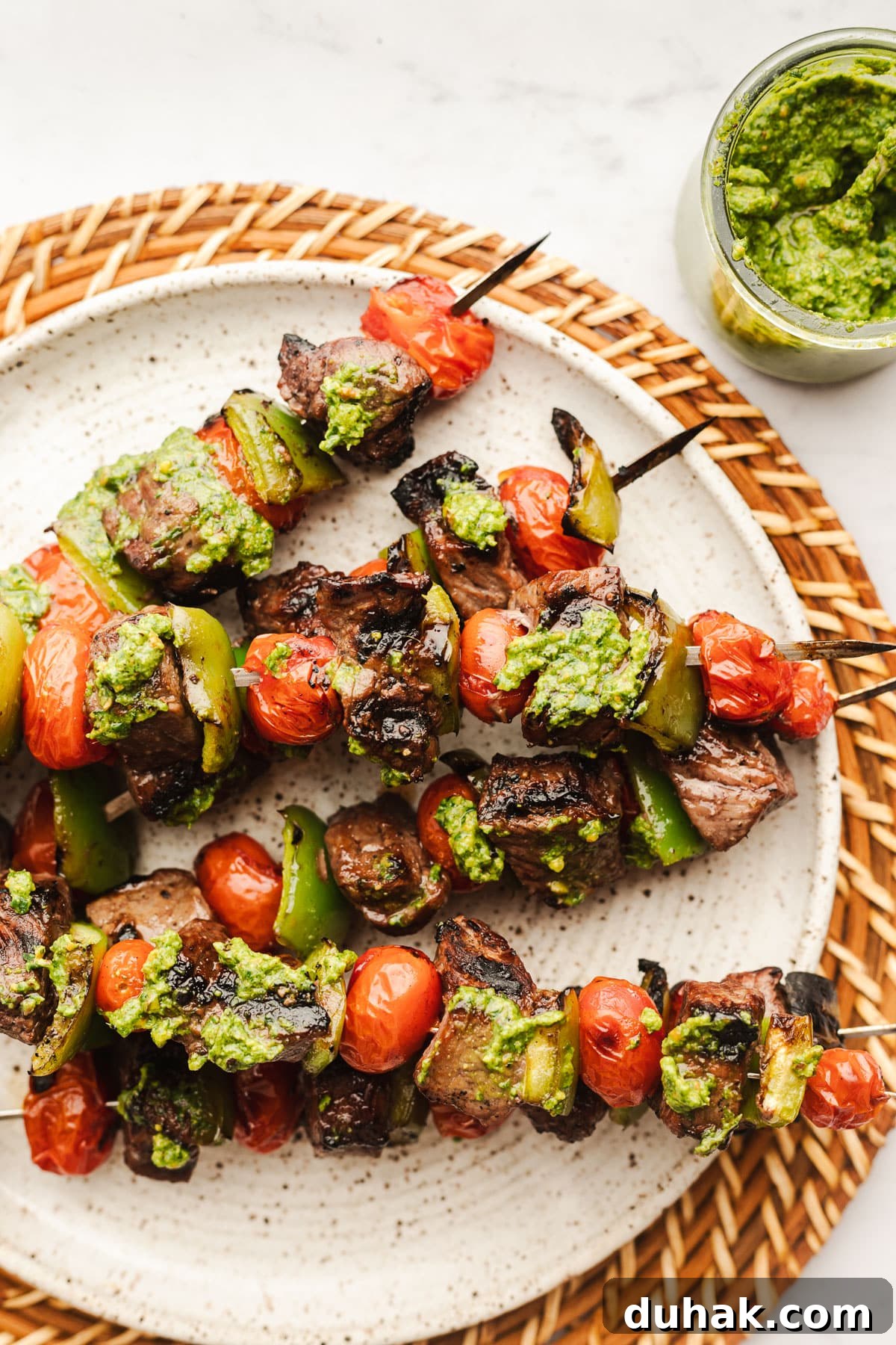 Pesto steak kabobs with blistered tomatoes and peppers