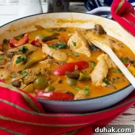 30-Minute Paprika Chicken Dinner Recipe 2 Paprika chicken in a blue cast iron pot with a red tea towel wrapped around it.