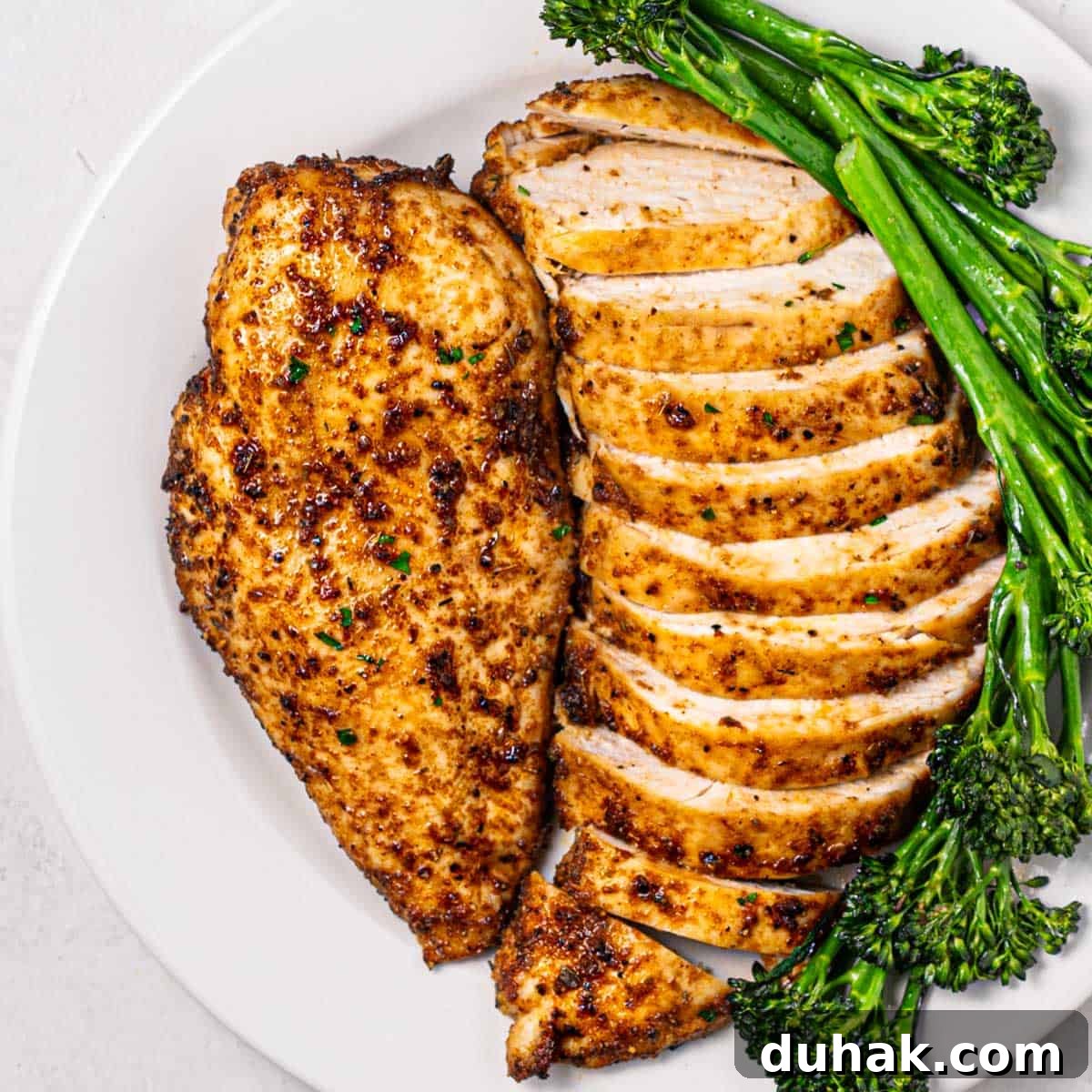 Crispy Juicy Air Fryer Chicken Breast Recipe in 20 Minutes 2 plate of air fryer chicken breasts with broccolini.