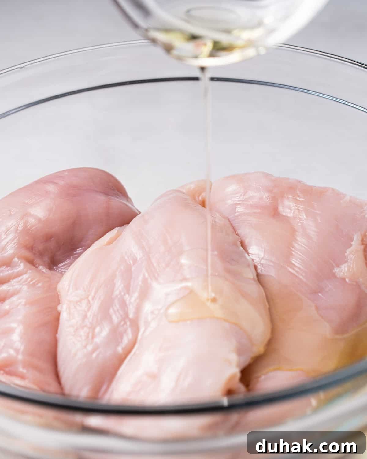 Crispy Juicy Air Fryer Chicken Breast Recipe in 20 Minutes 4 Drizzling olive oil on chicken breast.