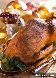 A whole roasted goose on a platter, garnished with parsley