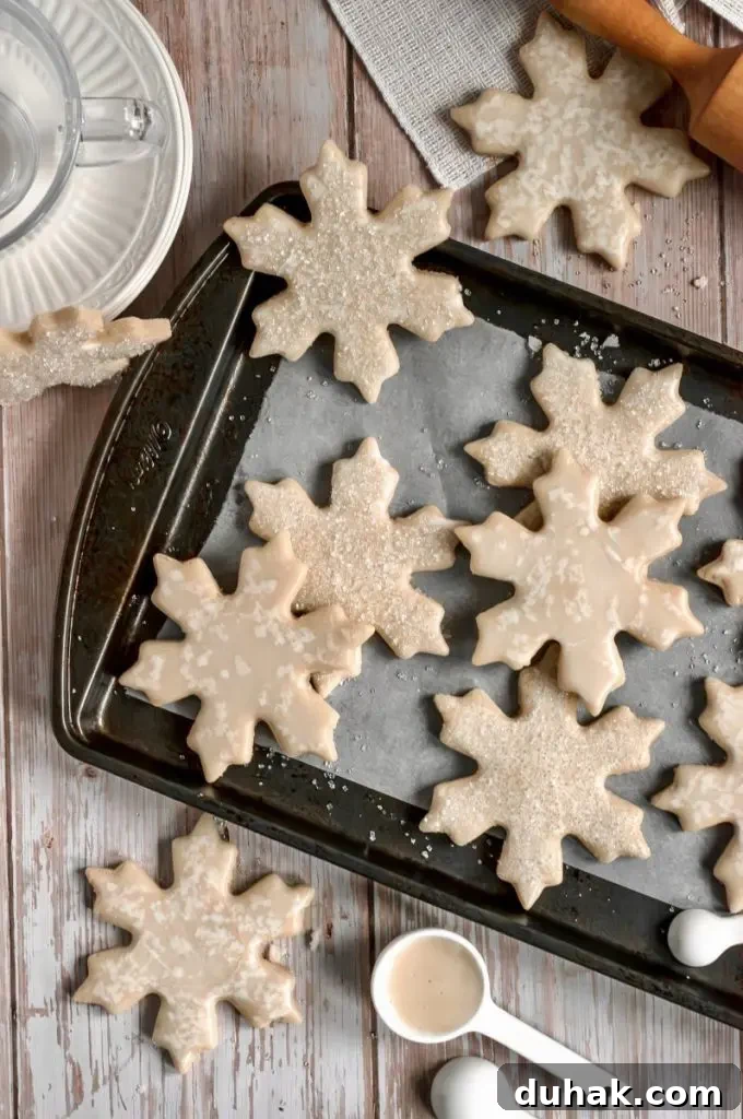 Vegan Gluten-Free Christmas Cookie Recipes 8 The prettiest dairy-free sugar cookies shaped like snowflakes and decorated with white icing and glittery sprinkles.