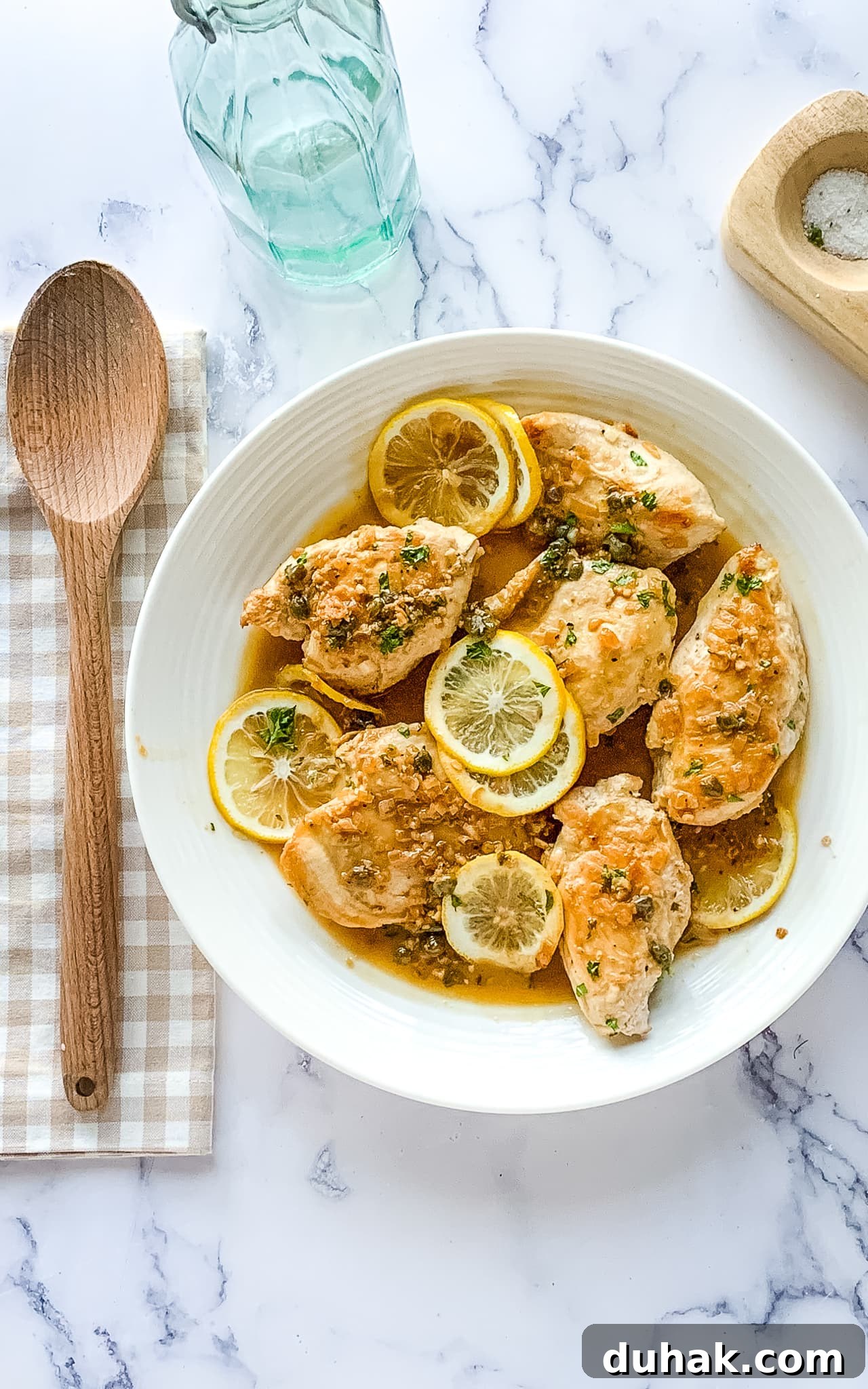 Cheesecake Factory Chicken Piccata Recipe: Copycat Instructions 2 Lemon caper chicken cutlets on a white serving platter.