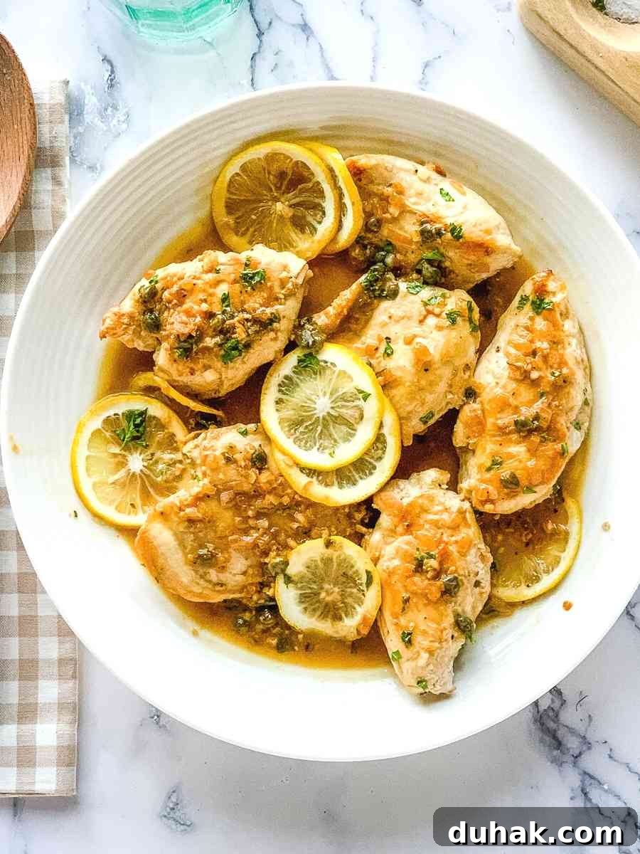 Cheesecake Factory Chicken Piccata Recipe: Copycat Instructions 6 Chicken piccata Cheesecake Factory copycat meal, served on a round white platter.