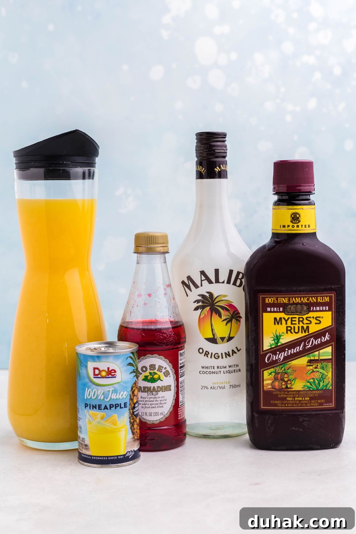 Bahama Mama Cocktail Recipe: Tropical Rum Drink Guide 3 Bottles of alcohol and juices on a marble table.