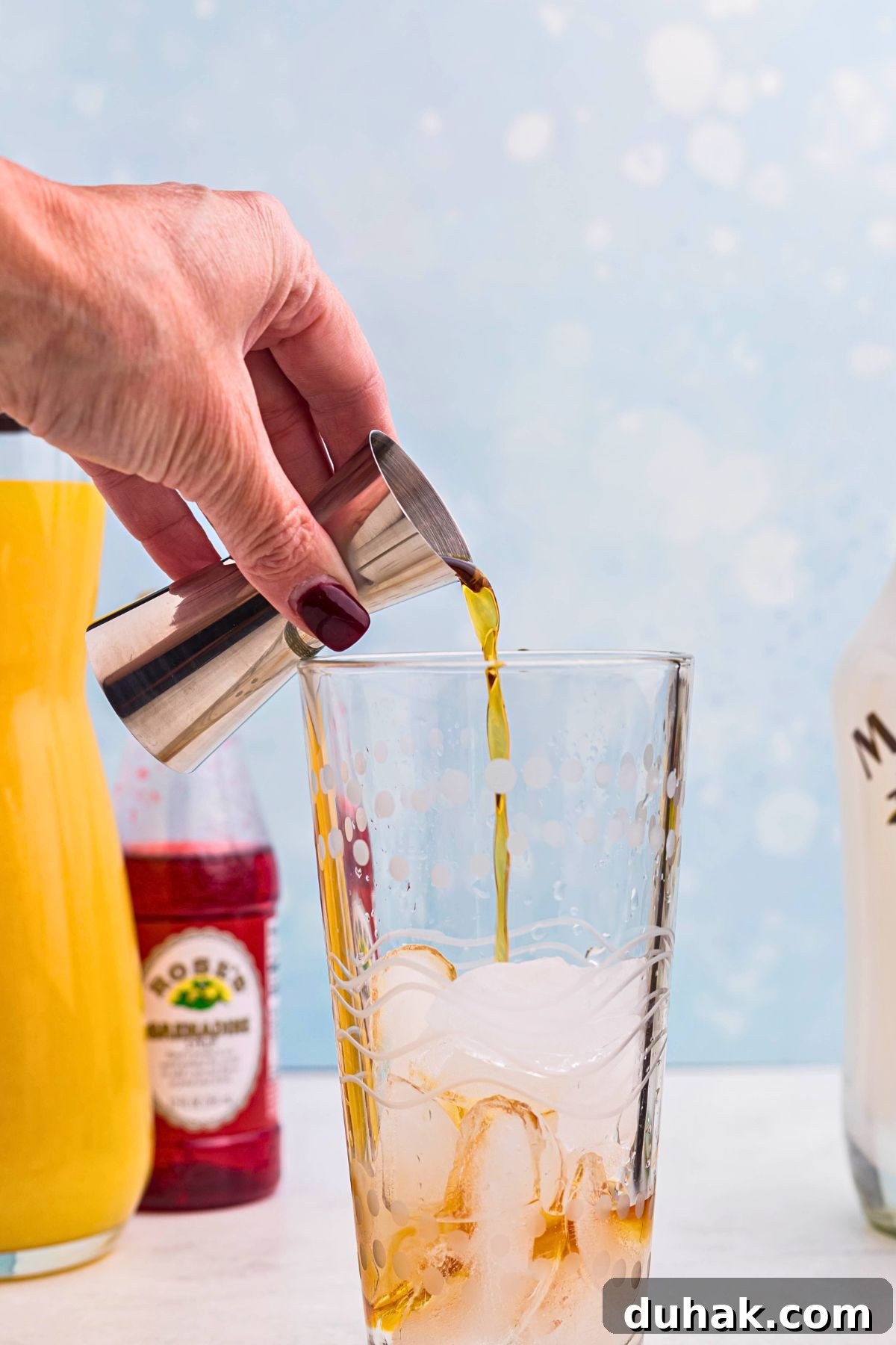 Bahama Mama Cocktail Recipe: Tropical Rum Drink Guide 4 Ingredients being poured into cocktail shaker with ice.