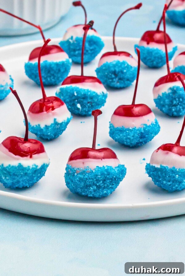 Bahama Mama Cocktail Recipe: Tropical Rum Drink Guide 10 Cherries coated in white chocolate, then dipped in blue sanding sugar, on a white round plate.