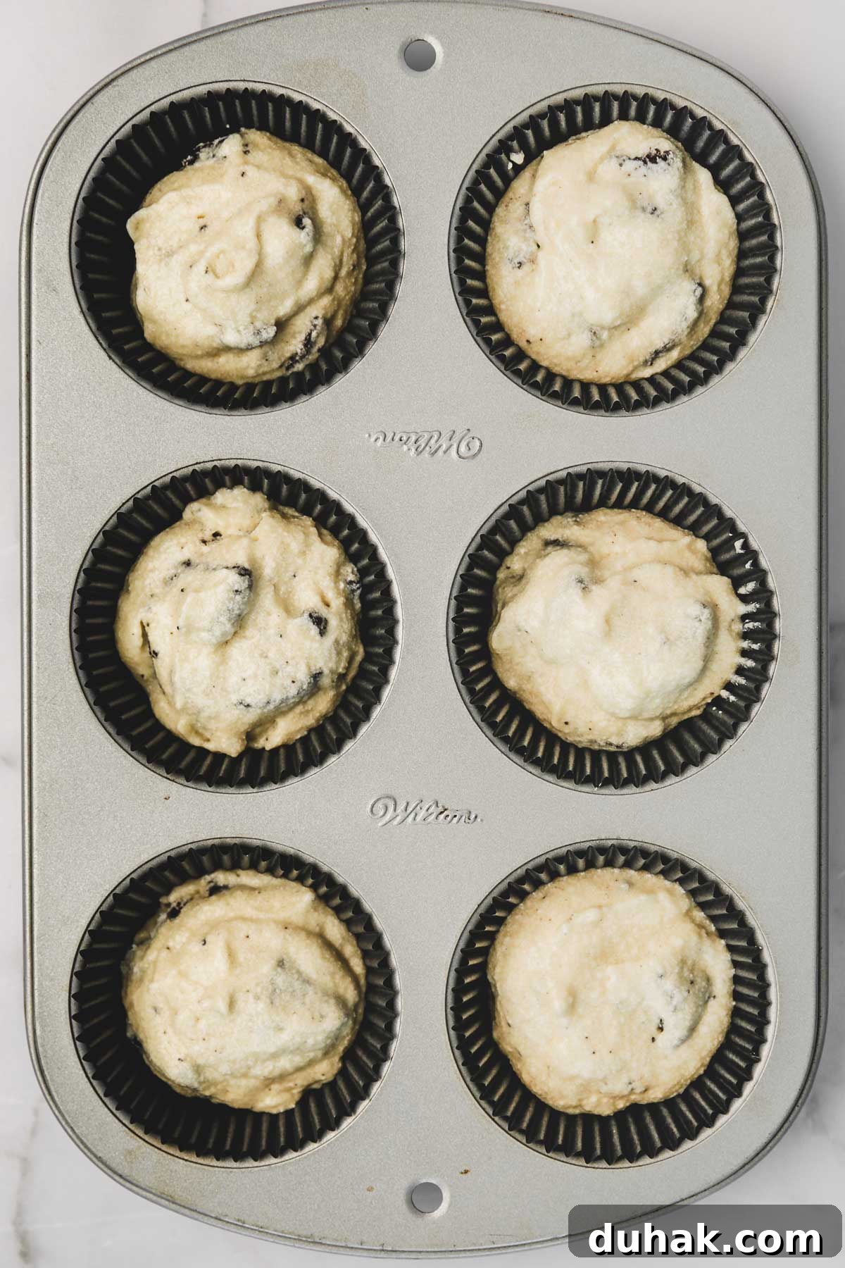 Oreo Stuffed Chocolate Cupcakes with Cream Cheese Frosting 6 oreo cupcake batter in lined cupcake pan before baking