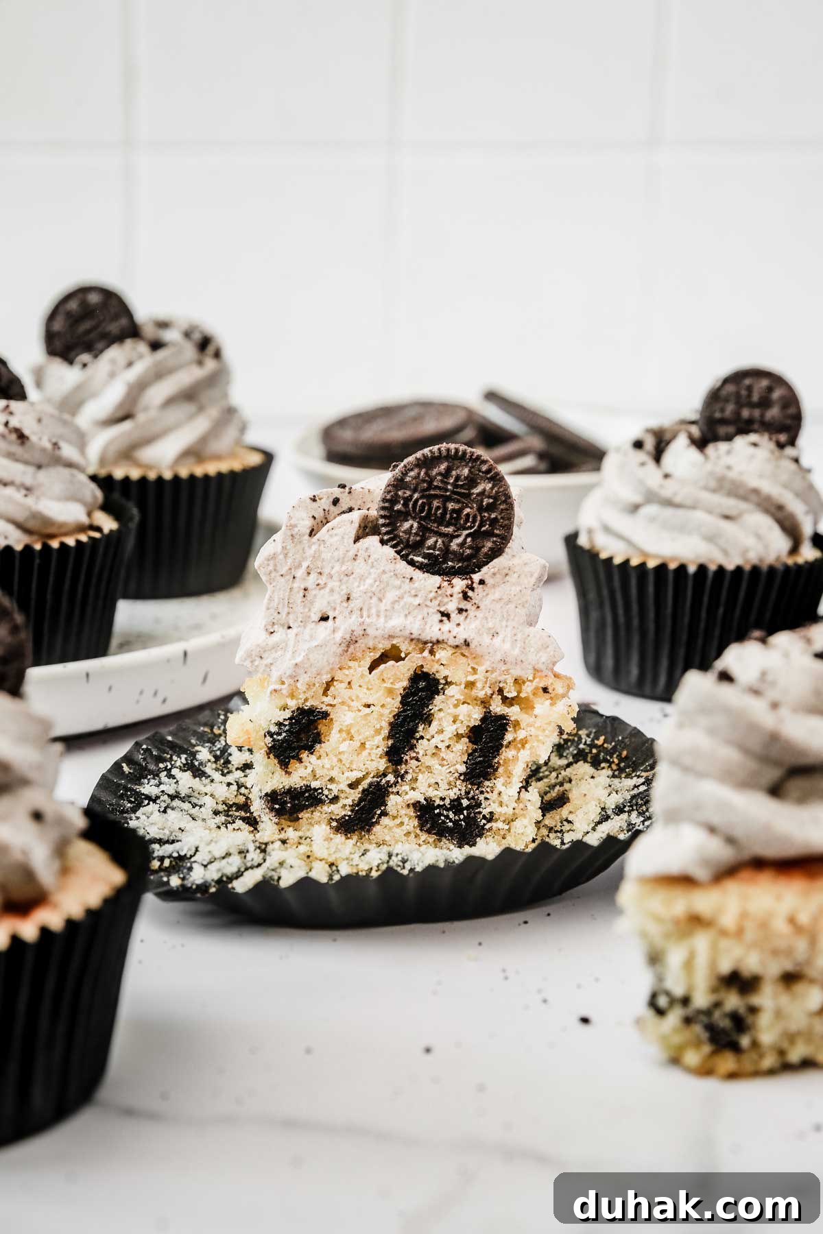 Oreo Stuffed Chocolate Cupcakes with Cream Cheese Frosting 9 oreo cupcake cut in half showing cookies and cream crumb