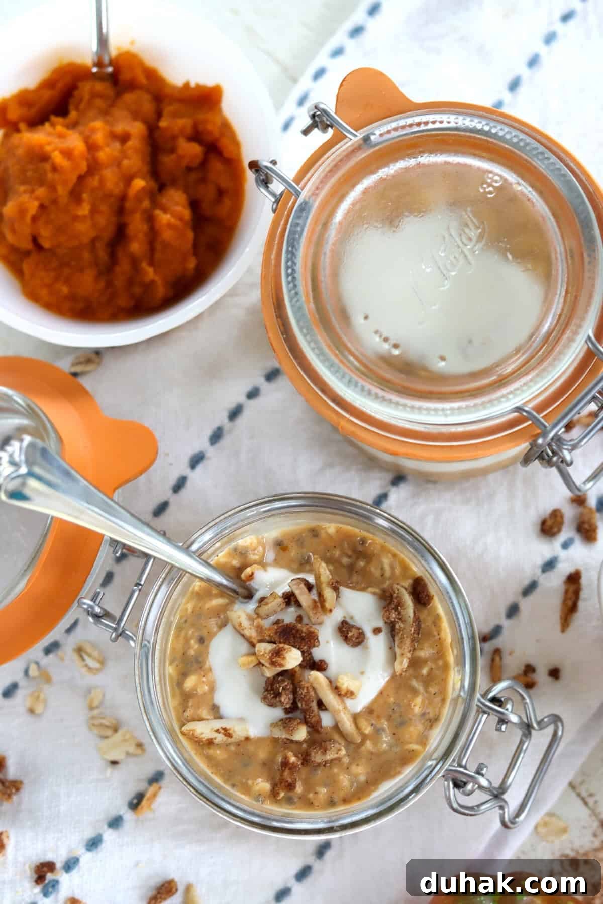 Pumpkin overnight oats in two glass lidded jars.