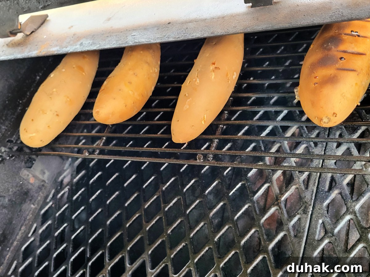 Smoked Sweet Potato Casserole with Brown Sugar Pecan Topping 3 sweet potatoes smoking on Pellet Pit Boss Grill