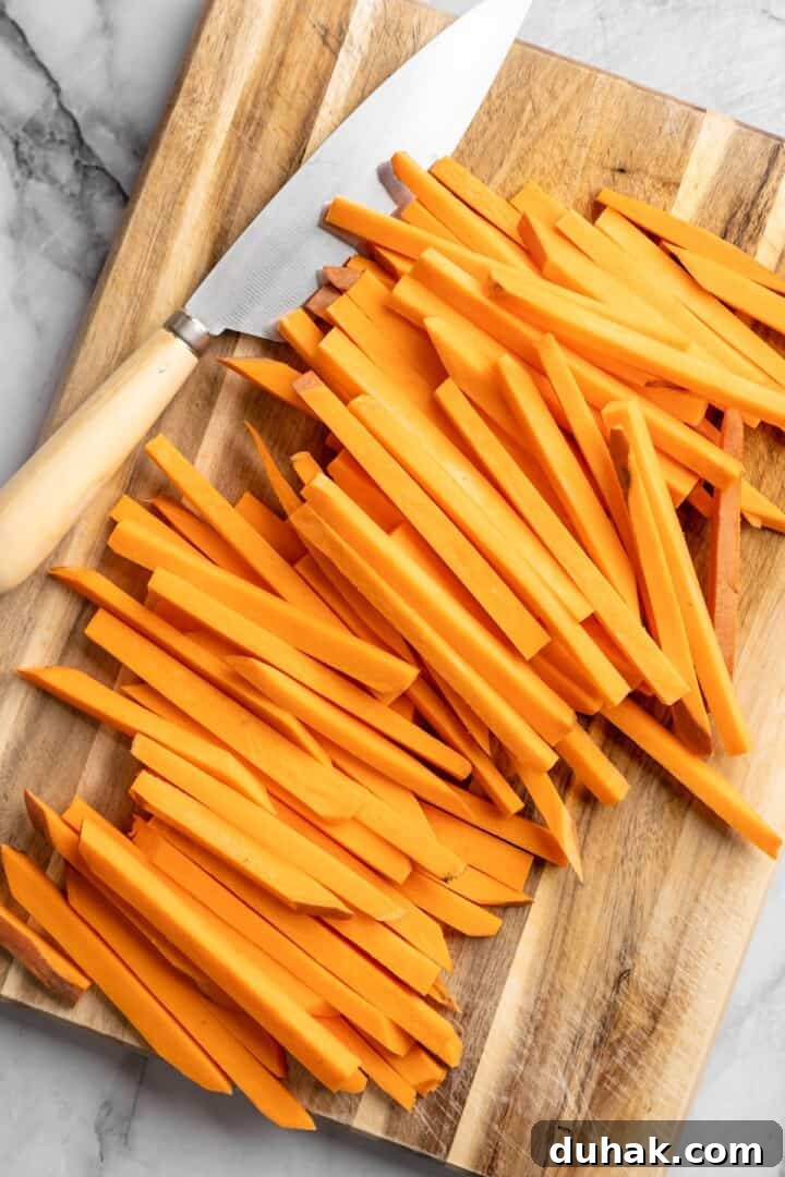 Cut the fries Sweet potato fries cut on board with knife