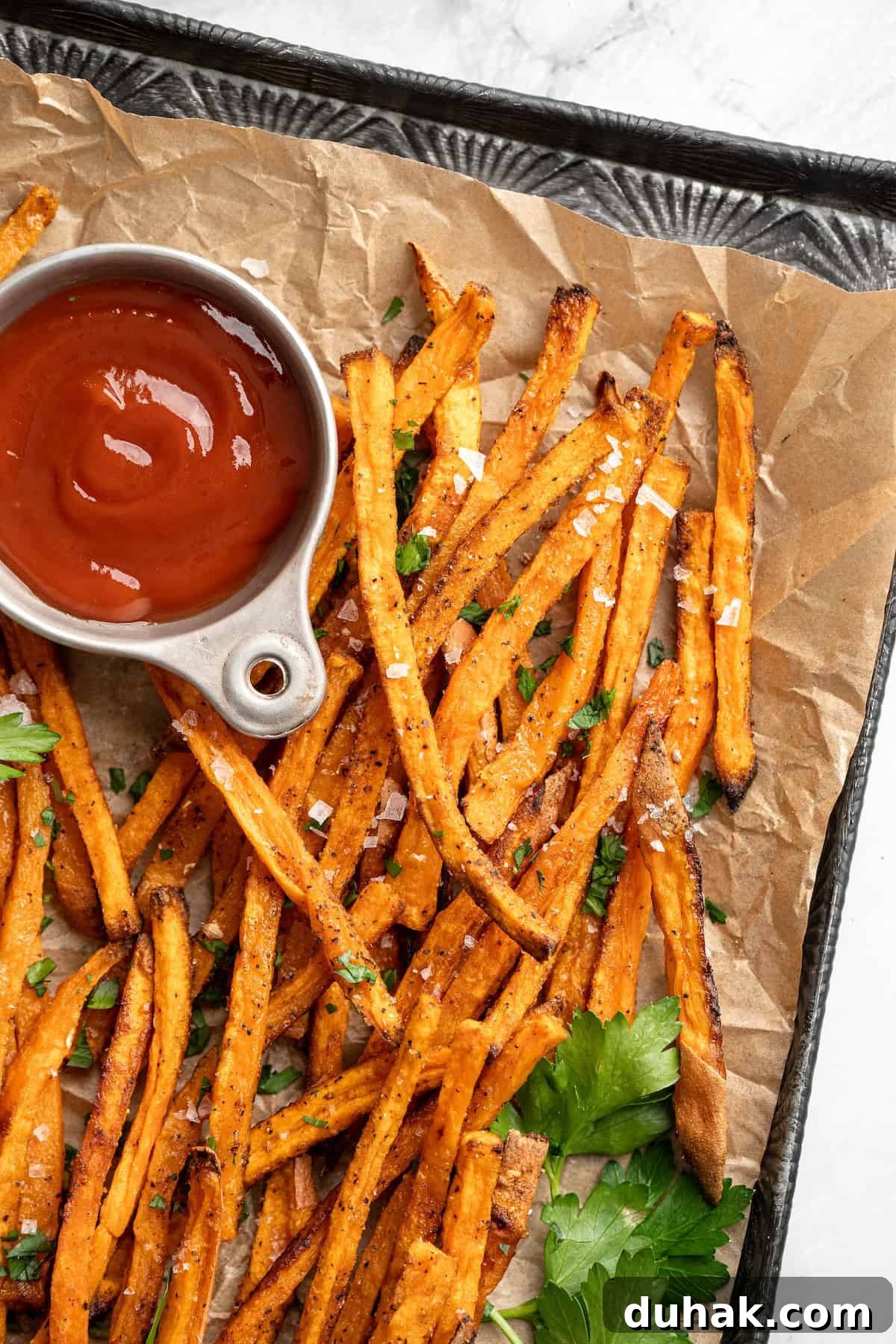 Crispy sweet potato fries with ketchup Crispy sweet potato fries with bowl of ketchup