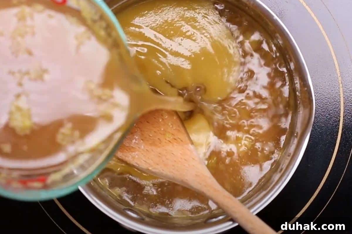 Pouring the pan juices in the small pot with mixed butter and flour.
