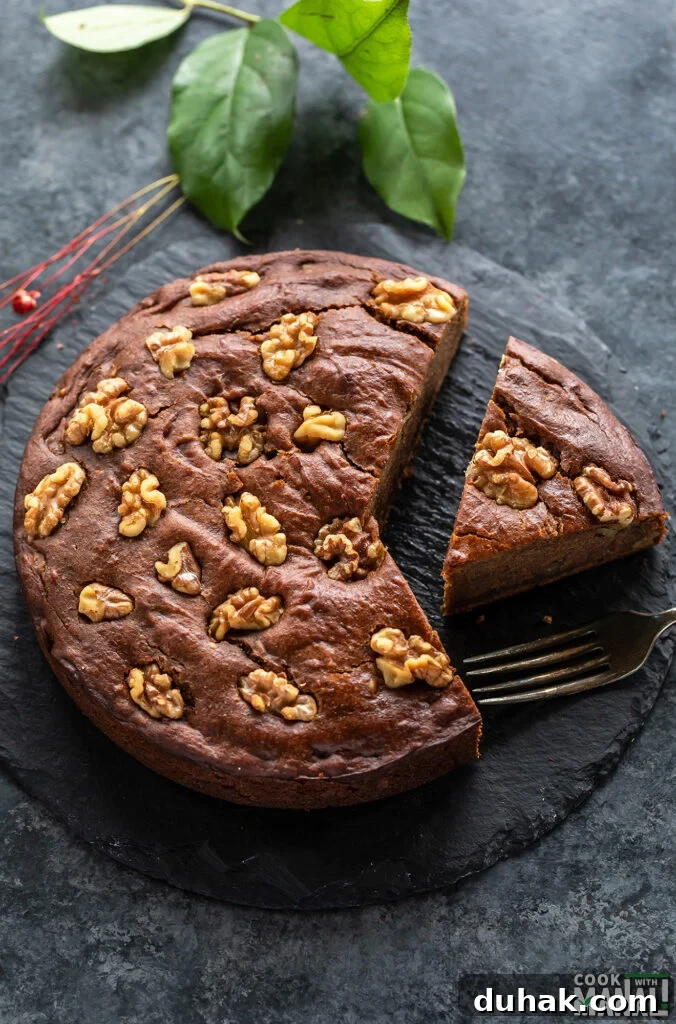 Vegan Date and Walnut Cake Recipe – Moist, No-Egg Dessert 2 a slice of date walnut cake cut from the cake and placed on a serving board