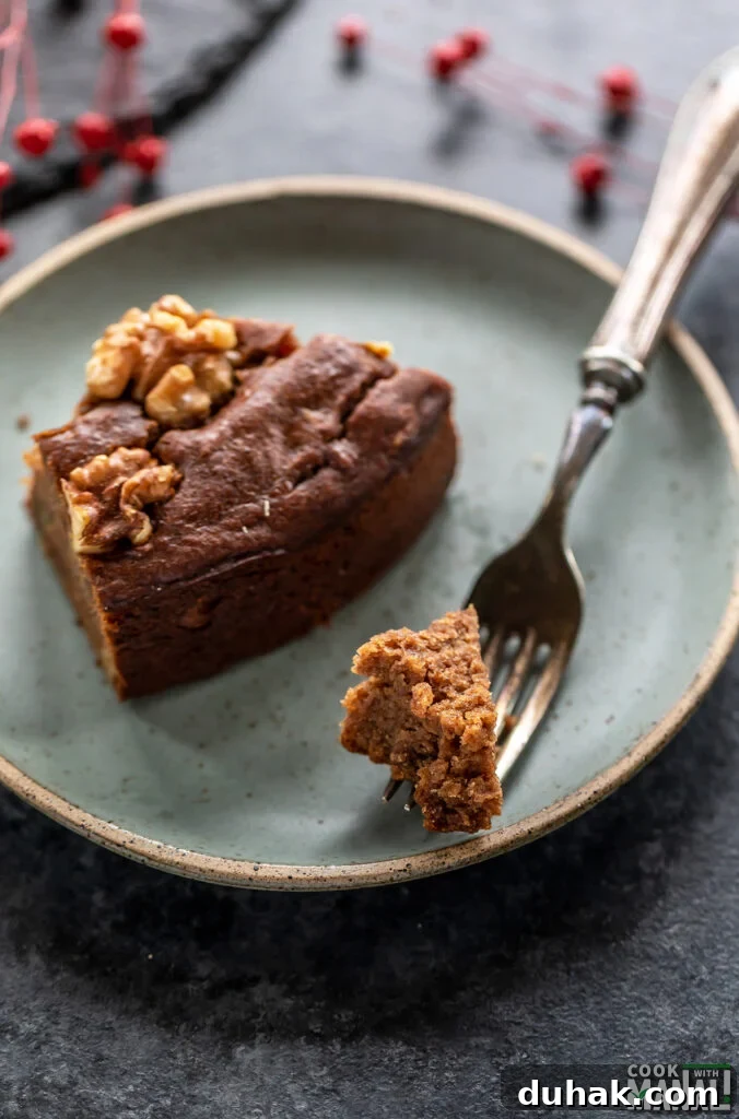 Vegan Date and Walnut Cake Recipe – Moist, No-Egg Dessert 7 a small piece from the cake on a fork to show the texture of the cake