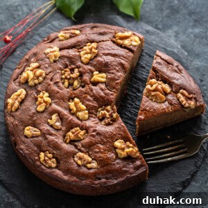 Vegan Date and Walnut Cake Recipe – Moist, No-Egg Dessert 8 a slice of date walnut cake cut from the cake and placed on a serving board
