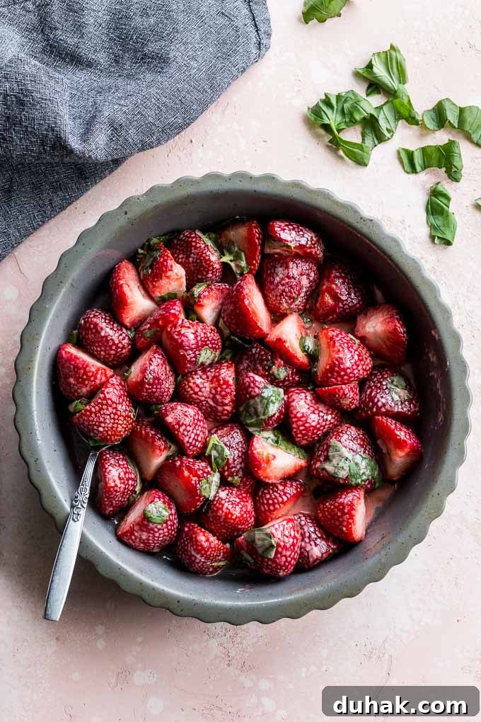 Strawberry basil mixture arranged on the bottom of a pie plate.