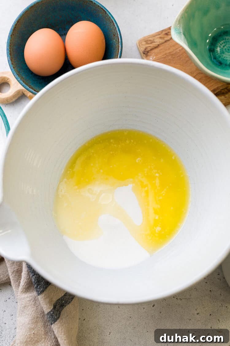 Granulated sugar and melted butter in a bowl.