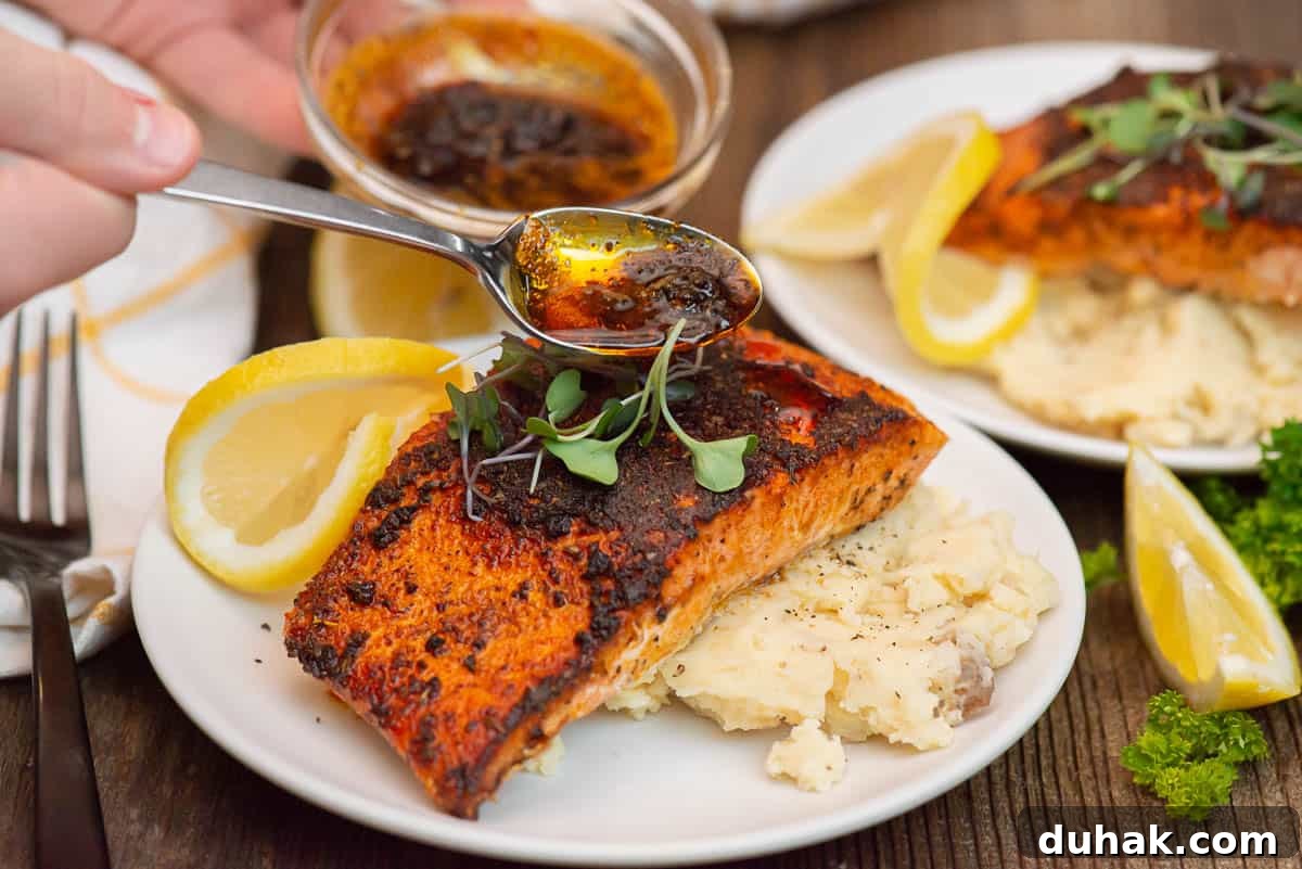 Blackened Salmon Recipe: Spicy Cajun Pan-Seared Fillets 13 spooning flavored butter over blackened salmon.