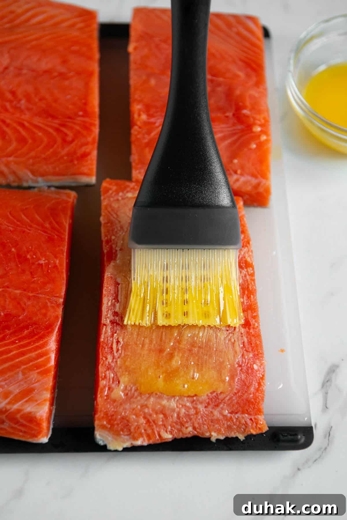 Blackened Salmon Recipe: Spicy Cajun Pan-Seared Fillets 5 brushing salmon filets with melted butter.