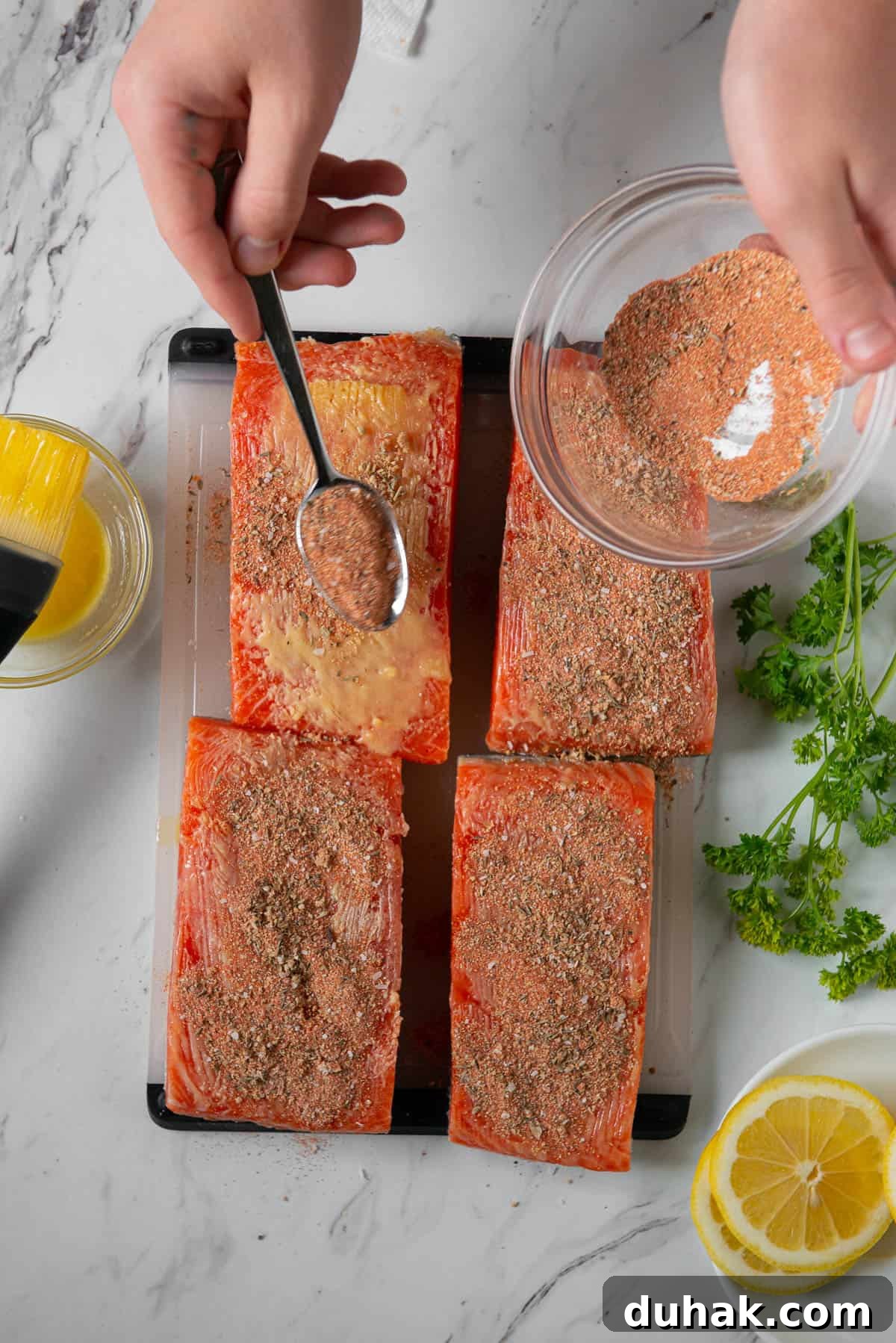 Blackened Salmon Recipe: Spicy Cajun Pan-Seared Fillets 7 Adding Cajun seasoning blend to butter brushed salmon filets.